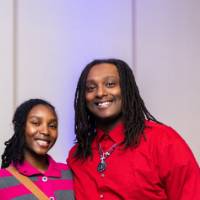 Two grads smile at Toast with blue lights